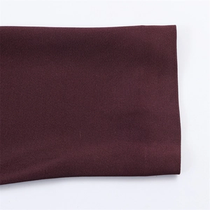 Macro shot of dark burgundy satin fabric texture with fine matte finish details