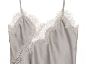 Close-up of grey satin camisole featuring delicate eyelash lace trim and silk texture