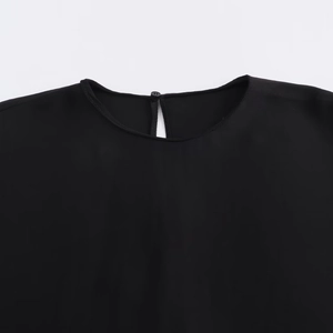 Detail of black long sleeve top showing button closure and keyhole neckline design