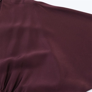 Close-up of deep purple satin fabric with elegant ruched details and smooth texture