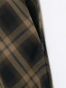 Detail view of the brown plaid skirt featuring a high-quality side invisible zipper