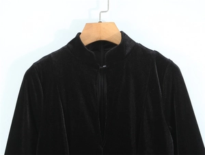 Detailed view of black velvet dress featuring Chinese stand collar and V-neckline slit