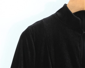 Detail of elegant black velvet dress neckline with a stand collar and back zipper