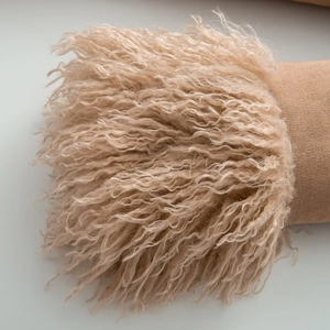 Detail of soft faux fur texture and suede stitching on winter slim fit coat