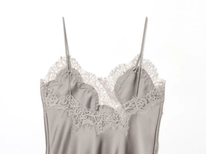 Macro view of silver satin camisole featuring delicate eyelash lace trim on V-neckline