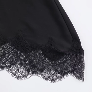 Detail shot of the black shirt hem showing delicate floral lace with eyelash trim texture