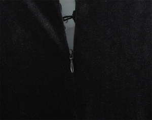 Close-up of invisible silver metal zipper on black slim-fit dress with shimmering texture