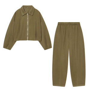 Flat lay of an olive green tracksuit featuring a zipped jacket and elastic waist pants