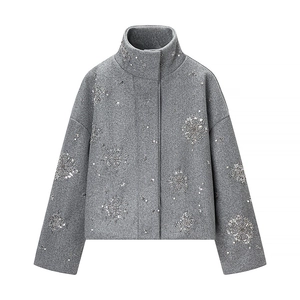 Detail of grey wool jacket featuring intricate snowflake sequins and bead embroidery