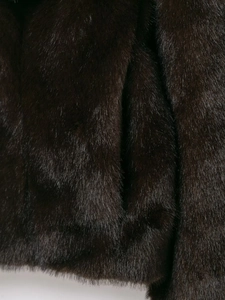 Close-up of thick dark brown faux fur texture with high gloss for winter coat detail