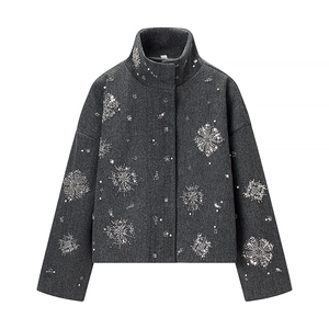 Detail of silver sequin snowflake embroidery on dark grey high collar wool jacket