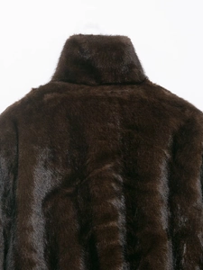 Close-up of deep brown faux fur coat showing high collar and dense plush texture