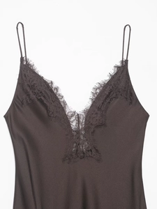 Detail of delicate eyelash lace trim on a silky deep-V neckline satin camisole top
