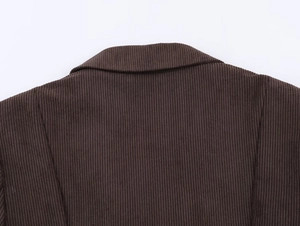 Detail shot of dark brown corduroy jacket back collar showing thick ribbed fabric texture