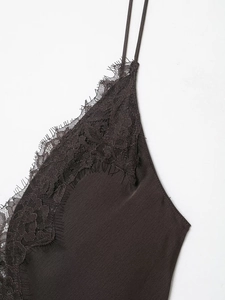 Close-up of silk-satin dress showing exquisite eyelash lace trim and fine shoulder straps