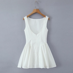 Detail view of the back zipper and pleated design on a white backless sundress