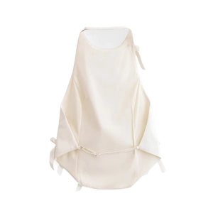 Close-up of champagne satin halter top detailing delicate side ties and smooth fabric