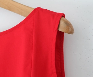 Close-up of red sleeveless dress showing fine fabric texture and clean neckline stitching