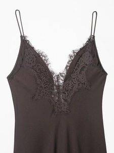 Detailed close-up of brown satin top with delicate eyelash lace trim and fine straps