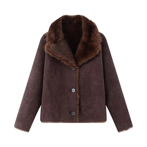 Detailed view of women's faux fur collar and suede texture on dark brown jacket