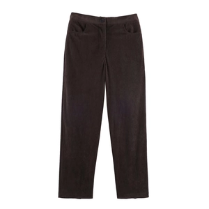 Detailed close-up of dark brown corduroy trousers with straight-leg cut and smooth texture