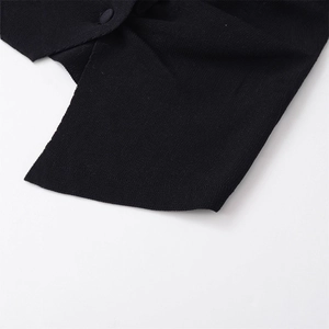 Women's minimalist black loose-fit knit sweater with elegant button detail