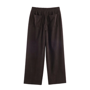 Detail of dark brown corduroy trousers featuring elastic waist and dual back pockets