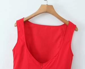 Macro shot of red off-shoulder dress featuring hidden back zipper and smooth fabric