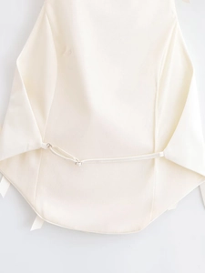 Detail of white halter top back with adjustable thin strap and silver metal ring