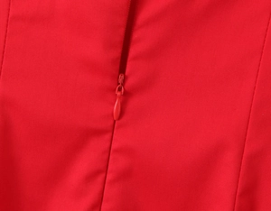 Detailed macro view showing a high-quality red fabric dress with a seamless invisible zipper