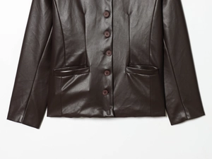 Detail of dark brown faux leather jacket showing single-breasted buttons and smooth PU texture