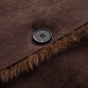Close-up of brown suede jacket showing texture, faux fur trim, and a black round button