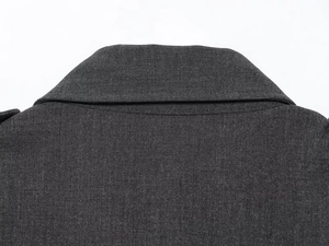 Detail of dark grey notch lapel and high-quality twill fabric texture on sleeveless dress