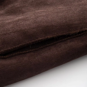 Detailed macro view of dark brown faux fur fabric texture with soft velvet finish
