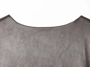 Detail of round neckline and refined stitching on a dark brown faux leather jacket