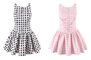 Detail of plaid sleeveless dress featuring front decorative buttons and pleated waistline