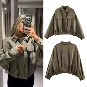 Detail view of army green utility bomber jacket with pleated hem and large chest pockets