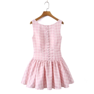 Close-up of pink gingham sleeveless dress with back buttons and pleated skirt detail