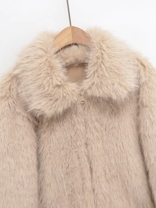 Close-up of fluffy faux fur texture and gold zipper on this beige winter jacket
