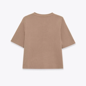 Detail view of the ribbed round neck and textured knit fabric on back of brown cardigan