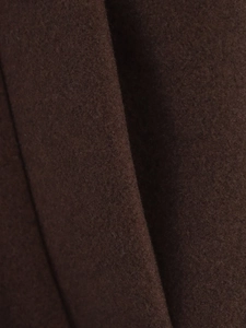 Detailed close-up of dark brown wool fabric showing fine texture and short plush finish
