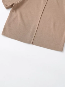Close-up of khaki knit top showing detailed hem finish and vertical decorative stitching