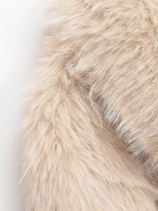 Macro shot of fluffy light beige faux fur texture showing premium soft synthetic fibers