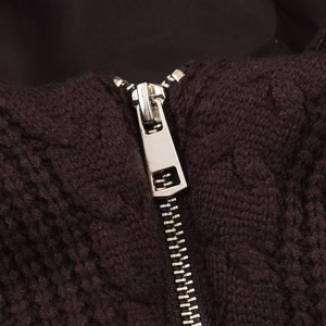 Macro shot of silver metal zipper on dark textured sherpa hooded winter jacket