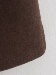 Macro detail of high-quality dark brown wool fabric texture on long fashion coat