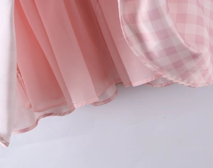 Detail of pink layered tulle with pleated texture and white gingham fabric for dress