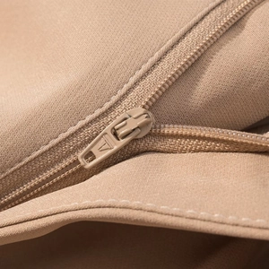 Macro shot of khaki fabric texture and color-matched zipper on a sleeveless vest set