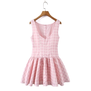 Detail of pink and white gingham dress featuring a deep U-back and hidden zipper closure