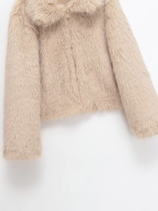 Detailed close-up of apricot faux fur jacket featuring a large collar and zipper texture