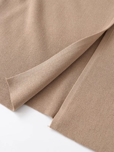 Close-up of premium camel knit fabric texture showing high-quality stitching detail